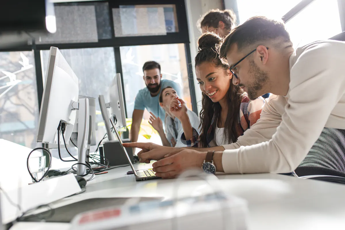 Group looking at laptop together