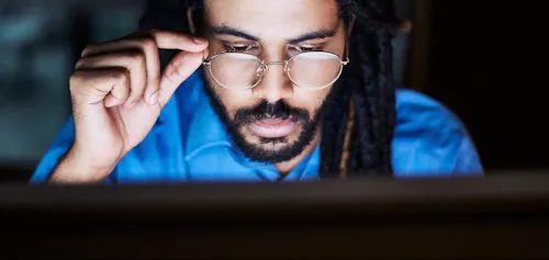 Man looking at screen with glasses