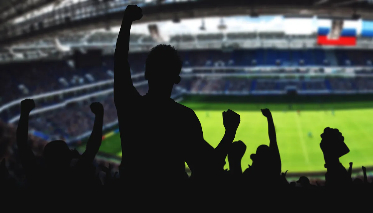 Silhouette of soccer fans at game in stadium