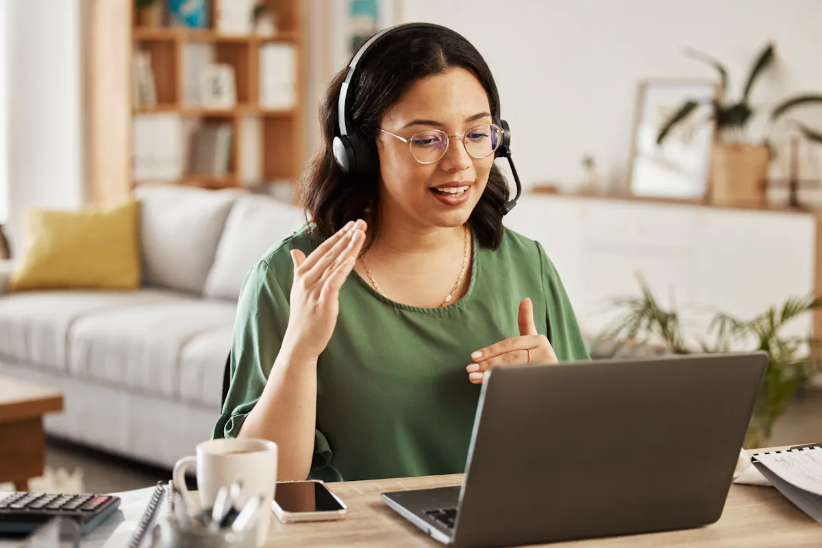 Woman in green shirt talking to screen