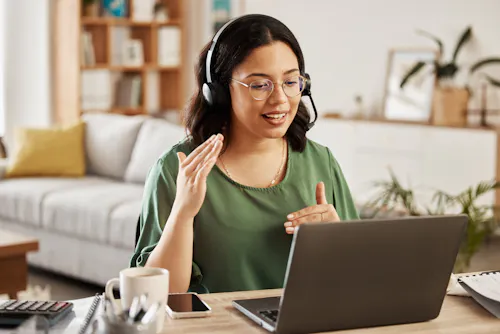 Woman in green shirt talking to screen