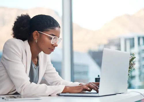 Woman leaning into tech work at office