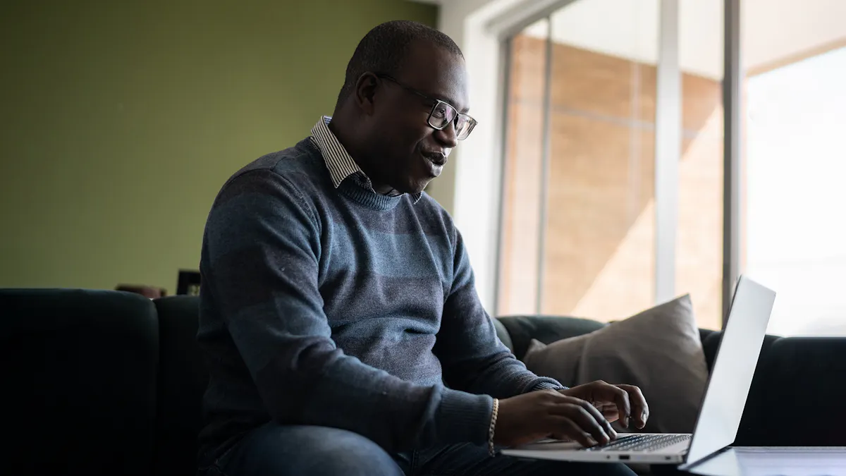 Black man smiling at screen