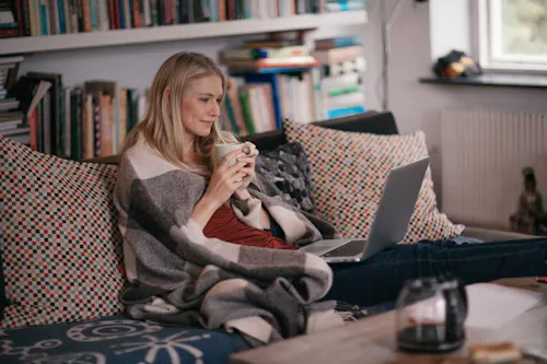 Cozy woman on couch job searching