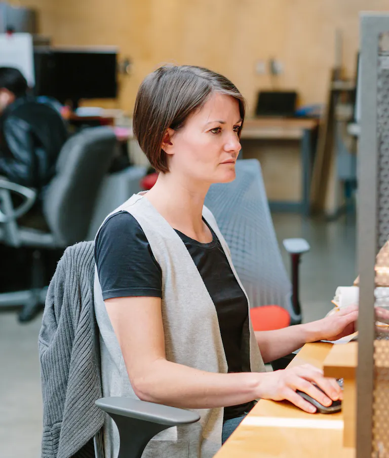 Focused woman in office working vertical