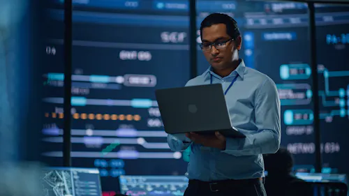 A cybersecurity analyst uses a laptop.