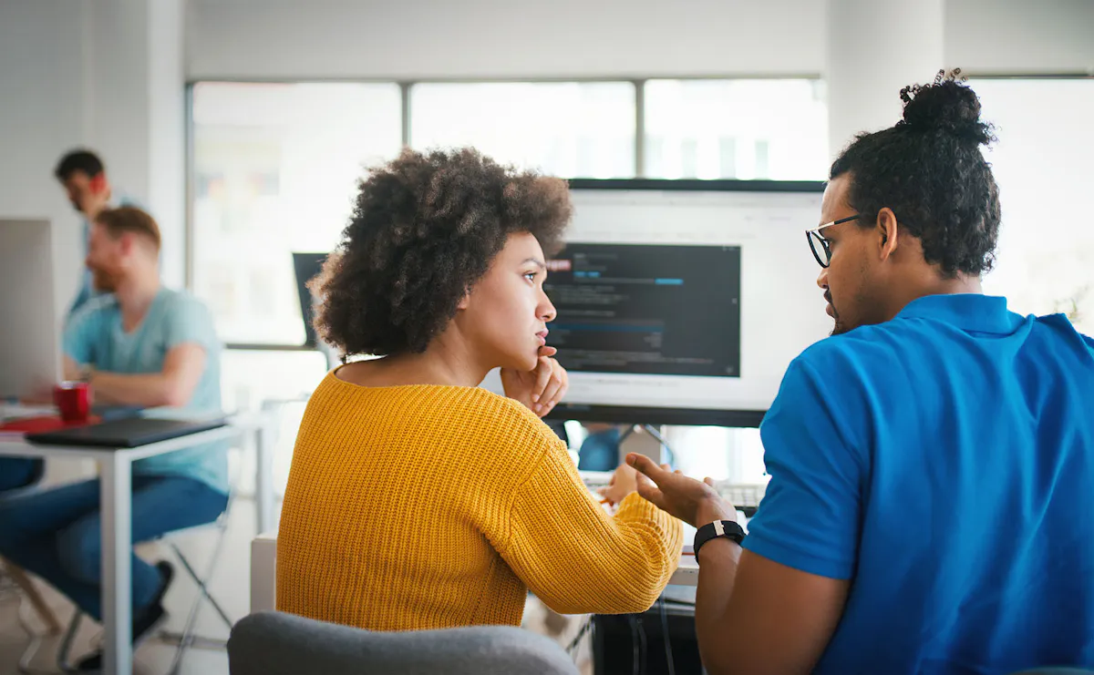 Man and woman looking at screen together back