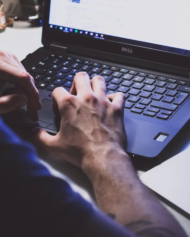 Man hands typing on dell computer