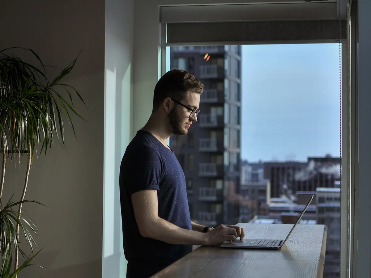 Man standing in city apartment