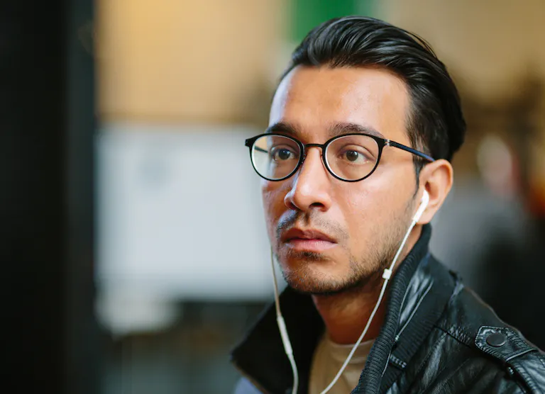 Man with glasses looking at screen small