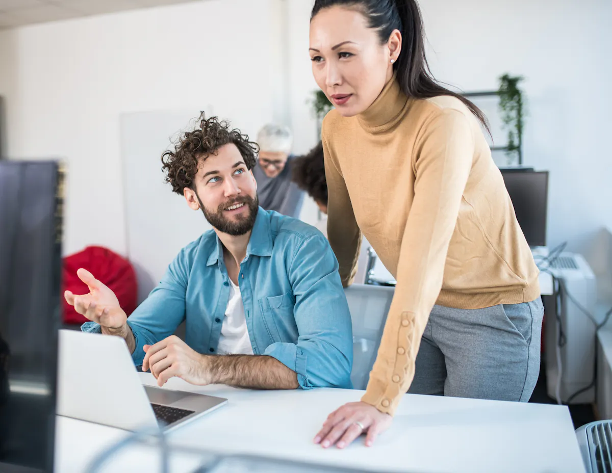 A product manager discusses new ideas with a colleague.