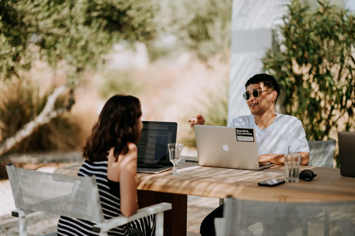 Two friends studying tech outside together