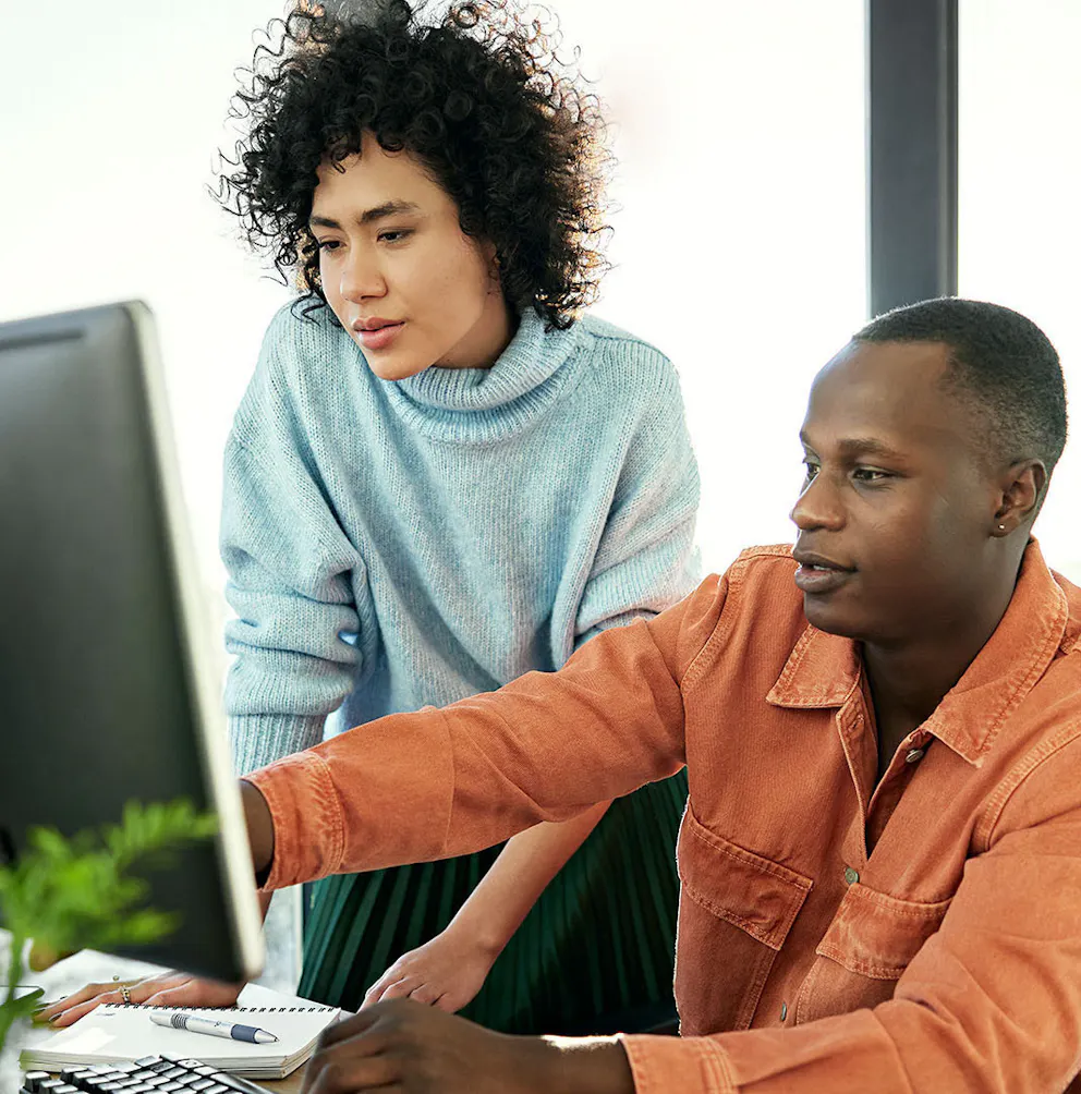 Woman and man pointing at screen