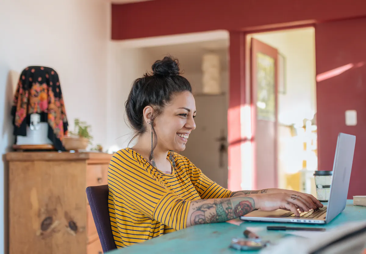 Woman in yellow working at computer