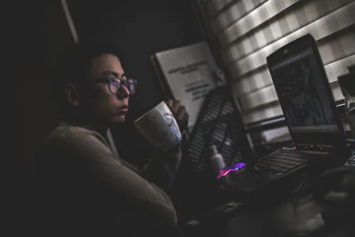 Working at night with coffee cup